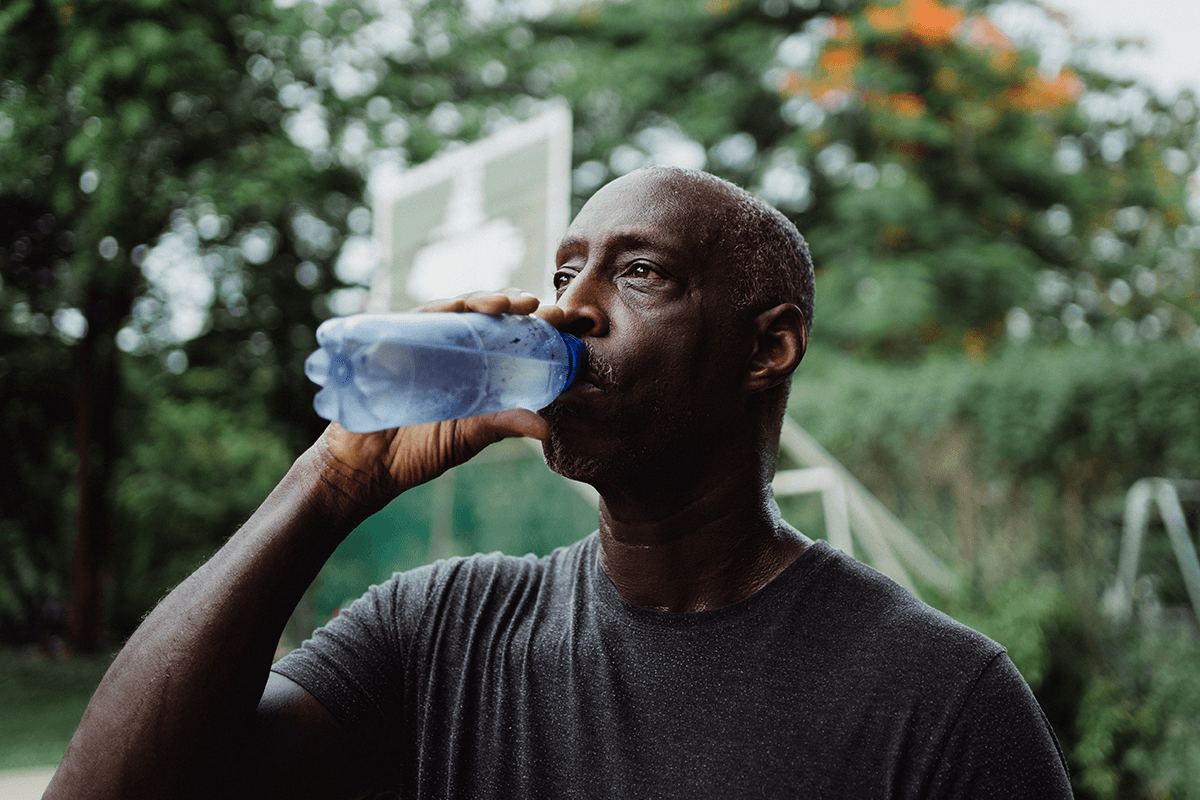 man drinking water jogger