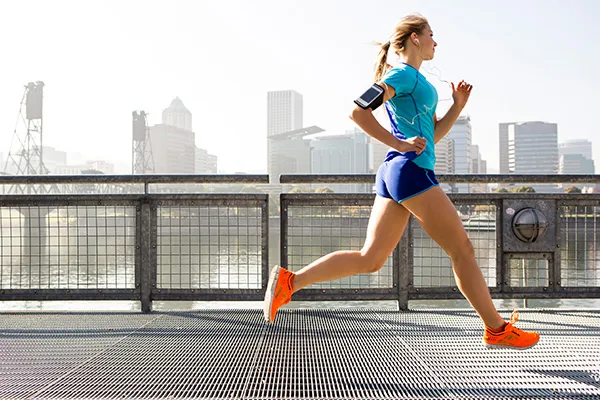 woman running on bridge